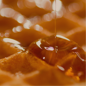 Caramel , maple or honey dripping on waffles
